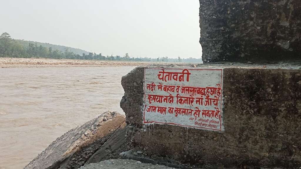चम्पावत में मानसून के दौरान नदी किनारे लगा चेतावनी बोर्ड और प्रशासन की सुरक्षा एडवाइजरी।