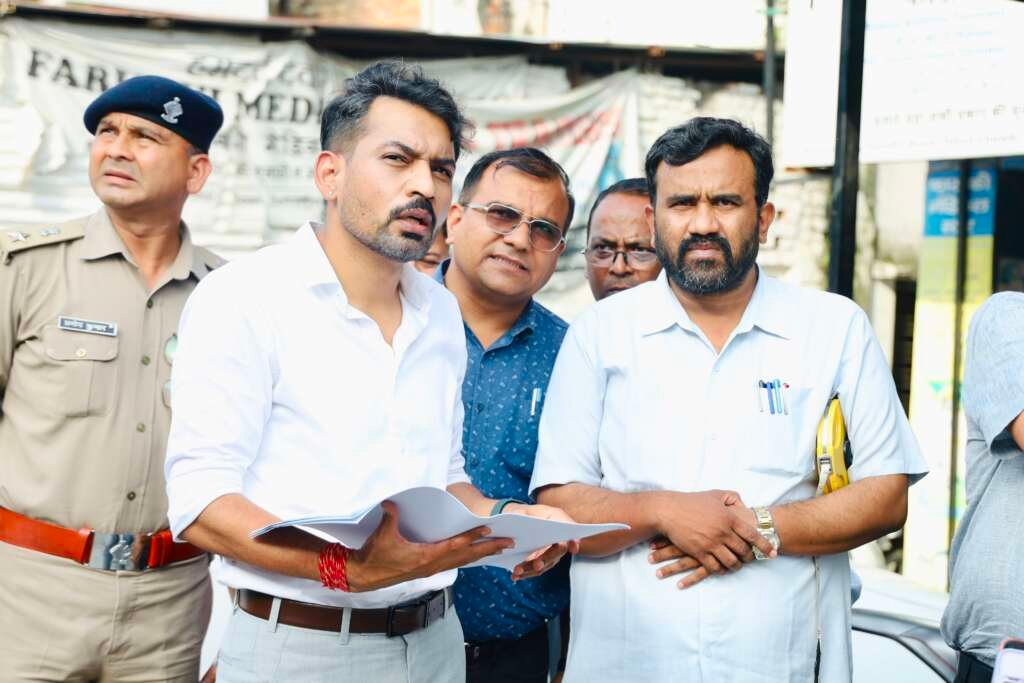 देहरादून में तहसील चौक सड़क चौड़ीकरण परियोजना का स्थलीय निरीक्षण करते जिलाधिकारी डॉ. आशीष चौहान।